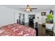 Main bedroom with dark wood bed frame, a flat screen TV and hardwood floors at 4122 S 185Th Ln, Goodyear, AZ 85338