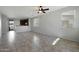 Bright living room with tile flooring and ceiling fan at 41240 W Capistrano Dr, Maricopa, AZ 85138