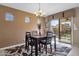 Dining area with dark wood table and chairs, and access to the backyard at 41267 W Hayden Dr, Maricopa, AZ 85138