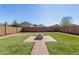 Spacious backyard with artificial turf and fire pit at 417 E Melanie St, San Tan Valley, AZ 85140