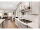 Modern kitchen with white cabinets and a gas cooktop at 4334 N Pioneer Dr, Litchfield Park, AZ 85340