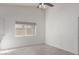 Spacious bedroom with light walls, wood-look floors, and large window at 4638 E Encanto St, Mesa, AZ 85205