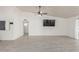 Spacious living room with hardwood floors and a large TV at 4638 E Encanto St, Mesa, AZ 85205