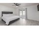 Main bedroom with wood-look floors, sliding door to patio, and ceiling fan at 4638 E Encanto St, Mesa, AZ 85205