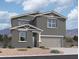 Two-story house with gray siding, stone accents, and a two-car garage at 47462 W Kenner Dr, Maricopa, AZ 85139