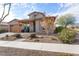 Charming house with stone facade, landscaping, and a welcoming front porch at 4892 N 205Th Dr, Buckeye, AZ 85396