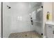 Large walk-in shower with marble tile and a rain shower head at 4892 N 205Th Dr, Buckeye, AZ 85396