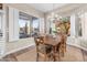 Bright dining room features a wooden table and chairs, large windows, and a chandelier at 5418 S Emerald Desert Dr, Gold Canyon, AZ 85118