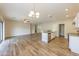 Open concept kitchen with granite counters, island, and white cabinets at 6314 W Virginia Ave, Phoenix, AZ 85035