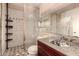 Bathroom with shower, granite vanity, and storage shelves at 6433 W Cortez St, Glendale, AZ 85304