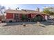 Ranch style home with red exterior, stone pathway, and mature landscaping at 6433 W Cortez St, Glendale, AZ 85304