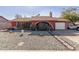 Red brick ranch style home with a landscaped front yard and a two-car garage at 6433 W Cortez St, Glendale, AZ 85304