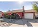 Red brick ranch home with a landscaped front yard and a two-car garage at 6433 W Cortez St, Glendale, AZ 85304