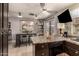 Open kitchen with island, seating, and dark cabinets at 6433 W Cortez St, Glendale, AZ 85304