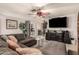 Living area features sectional sofa, large TV, and brick fireplace at 6433 W Cortez St, Glendale, AZ 85304