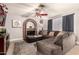 Living room featuring a sectional sofa, brick fireplace, and ceiling fan at 6433 W Cortez St, Glendale, AZ 85304