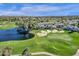 Aerial view of community near golf course and lake at 7272 E Gainey Ranch Rd # 42, Scottsdale, AZ 85258