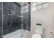 Clean bathroom with a tub shower, toilet and dark tile at 9655 N 130Th St, Scottsdale, AZ 85259