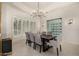 Elegant dining room featuring a large table, wine storage, and chandelier at 9655 N 130Th St, Scottsdale, AZ 85259