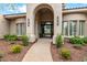 Elegant entryway with arched doorway and landscaping at 9655 N 130Th St, Scottsdale, AZ 85259