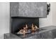 Modern linear fireplace with marble surround and driftwood at 9655 N 130Th St, Scottsdale, AZ 85259