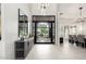 Elegant foyer with high ceilings, modern light fixture, and views of the front landscape through glass front door at 9655 N 130Th St, Scottsdale, AZ 85259