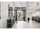 Grand foyer features a contemporary console table, mirrors, and a decorative light fixture, creating an inviting entrance at 9655 N 130Th St, Scottsdale, AZ 85259