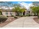 Single story home with manicured landscaping and curved driveway at 9655 N 130Th St, Scottsdale, AZ 85259