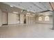 Large garage with epoxy floors, built-in shelving, and storage cabinets offers ample space for vehicles and projects at 9655 N 130Th St, Scottsdale, AZ 85259
