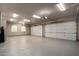 Spacious three-car garage with epoxy flooring, arched windows, and automatic door openers at 9655 N 130Th St, Scottsdale, AZ 85259