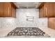 Gas cooktop and custom backsplash in modern kitchen at 9655 N 130Th St, Scottsdale, AZ 85259