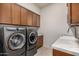 Modern laundry room with washer, dryer and marble countertop at 9655 N 130Th St, Scottsdale, AZ 85259