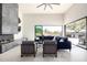 Bright living room boasts a modern fireplace, high ceilings, and expansive sliding glass doors to the outdoor living area at 9655 N 130Th St, Scottsdale, AZ 85259