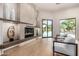 Relaxing living room with a fireplace and views to the backyard at 9655 N 130Th St, Scottsdale, AZ 85259