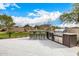 Modern outdoor kitchen with grill and bar seating at 9655 N 130Th St, Scottsdale, AZ 85259