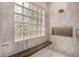 Elegant shower with glass block window and built-in seat at 9655 N 130Th St, Scottsdale, AZ 85259
