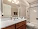 Clean bathroom with a bathtub, toilet and vanity with quartz countertop at 10020 N 109Th Ave, Sun City, AZ 85351