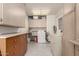 Bright laundry room with built in cabinets and countertop space at 10020 N 109Th Ave, Sun City, AZ 85351