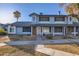 Two-story townhome with brick and blue siding, featuring a walkway and landscaping at 10101 N 91St Ave # 81, Peoria, AZ 85345