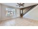 Living room features tile floors, neutral walls, and stairs to upper level at 10101 N 91St Ave # 81, Peoria, AZ 85345