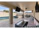 Covered patio, pool, and lounge area; perfect for entertaining at 10302 E Dolphin Ave, Mesa, AZ 85208