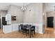 Bright dining area with a farmhouse table and six chairs, hardwood floors at 10302 E Dolphin Ave, Mesa, AZ 85208