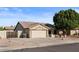 Single-story home with a two-car garage and desert landscaping at 10302 E Dolphin Ave, Mesa, AZ 85208