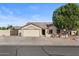 Single-story home with a two-car garage and landscaped front yard at 10302 E Dolphin Ave, Mesa, AZ 85208