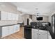 Modern kitchen with island, white cabinets, and black countertops at 10302 E Dolphin Ave, Mesa, AZ 85208