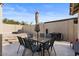 Outdoor patio with seating for six and umbrella at 10302 E Dolphin Ave, Mesa, AZ 85208