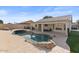 Large kidney shaped pool and patio with covered seating at 10302 E Dolphin Ave, Mesa, AZ 85208