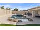 Spacious backyard with a kidney shaped pool and patio at 10302 E Dolphin Ave, Mesa, AZ 85208