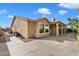 This backyard features a covered patio, desert landscaping, and a concrete walkway at 10626 E Voax Dr, Sun Lakes, AZ 85248