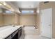 Bathroom with double vanity and a bathtub at 10626 E Voax Dr, Sun Lakes, AZ 85248